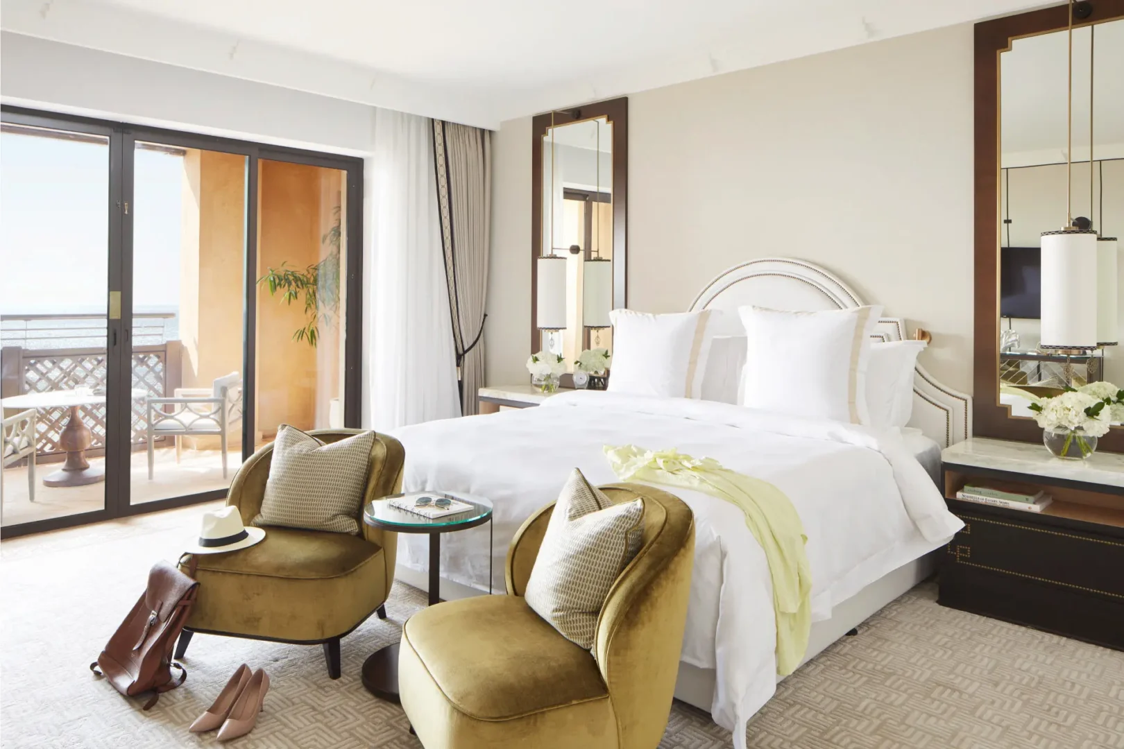 ocean suite bedroom at jumeirah mina al salam dubai featuring a king-size bed, rich arabian-inspired décor, elegant furnishings and private balcony with views of the arabian gulf
