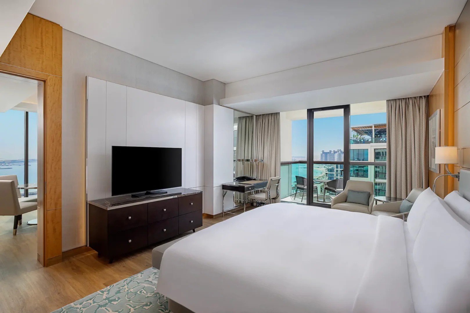king one bedroom suite with sea view balcony bed at hilton dubai palm jumeirah