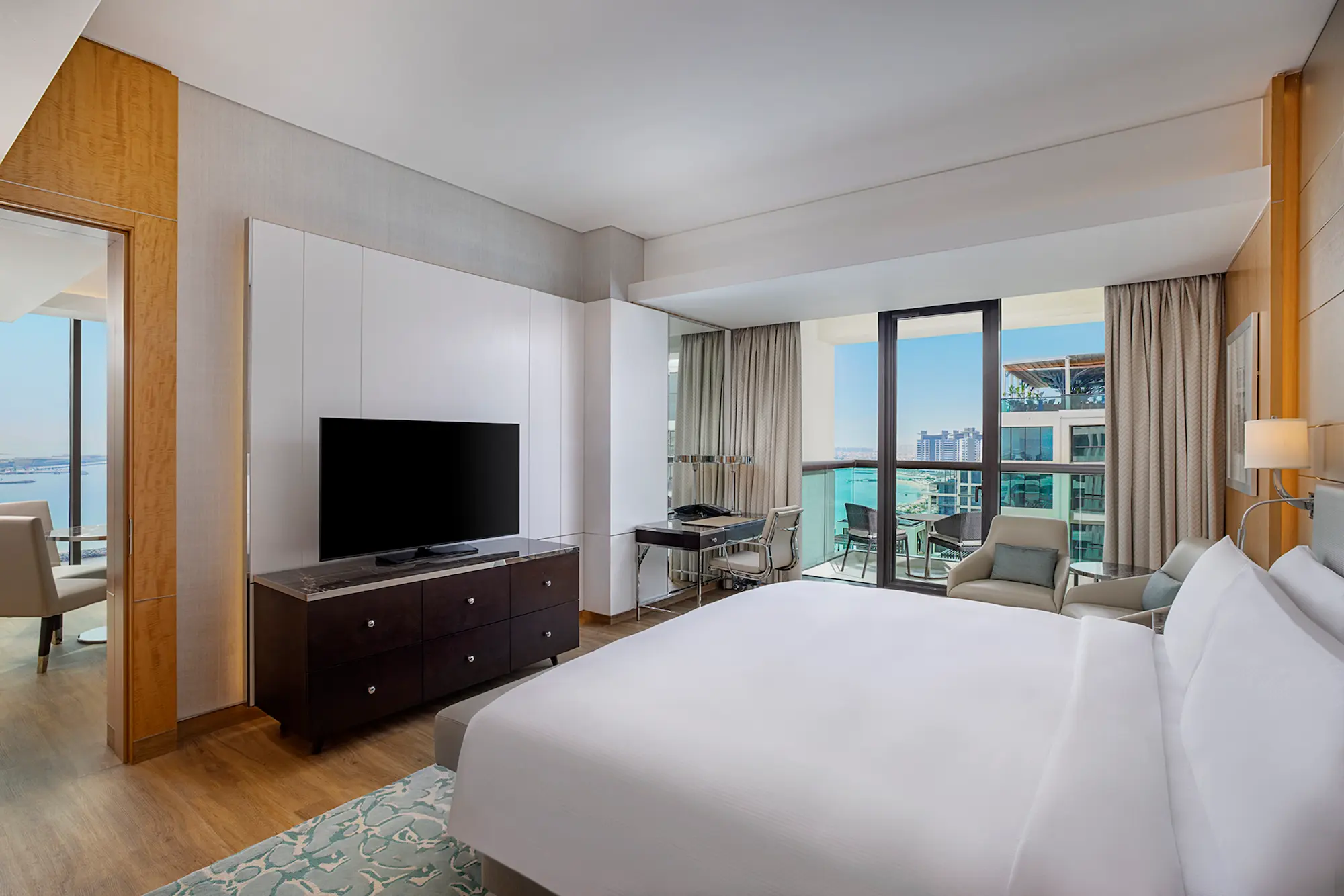 king one bedroom suite with sea view balcony bed at hilton dubai palm jumeirah