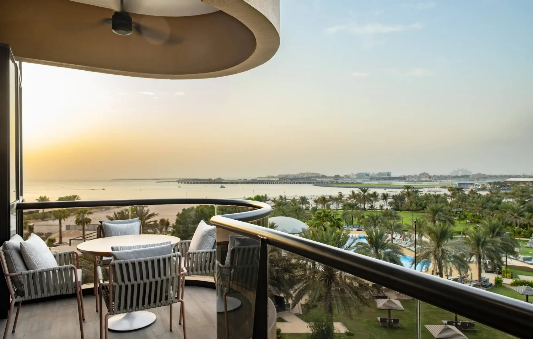club suite balcony at le royal meridien beach resort and spa dubai featuring private outdoor seating area with views over the resort gardens and arabian gulf