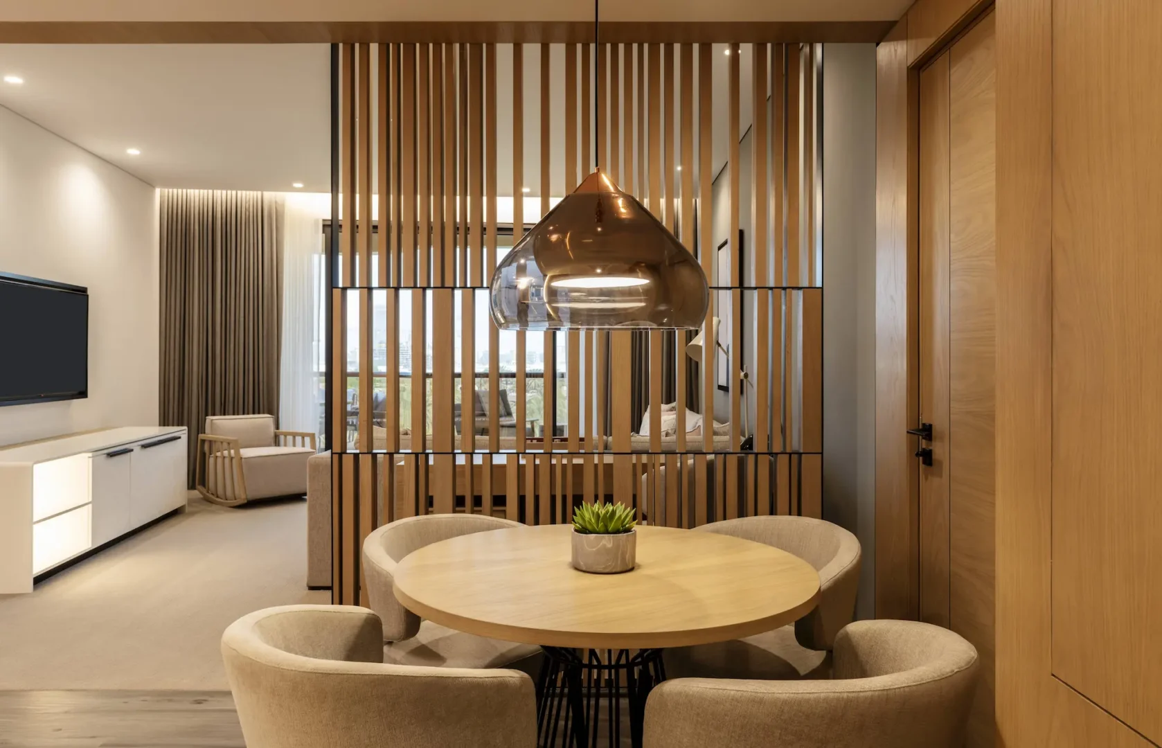 club suite dining area at le royal meridien beach resort and spa dubai featuring elegant dining table, modern décor and large windows with views over the resort gardens and arabian gulf