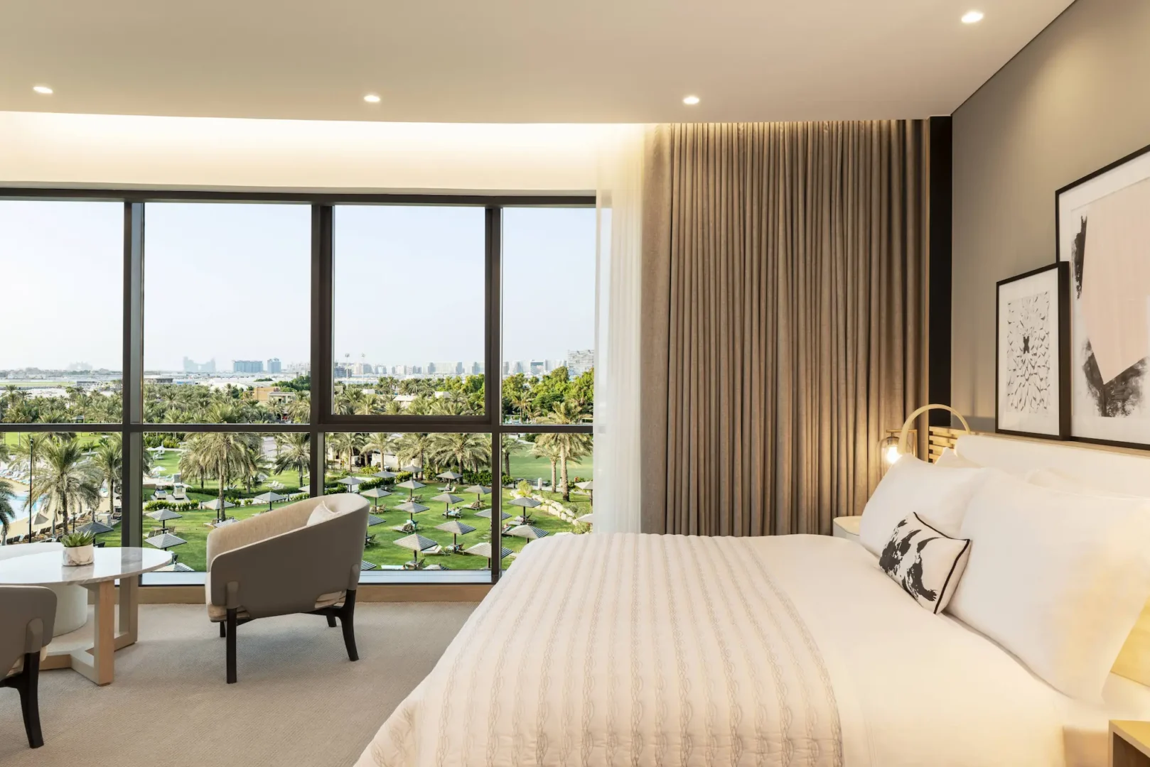 club suite master bedroom at le royal meridien beach resort and spa dubai featuring plush king-size bed, elegant modern furnishings and floor-to-ceiling windows with garden or sea views