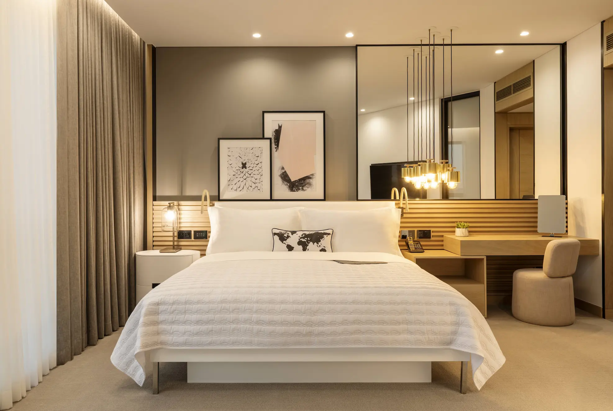 club suite master bedroom at le royal meridien beach resort and spa dubai featuring king-size bed, contemporary décor and large windows with views over the resort gardens and arabian gulf