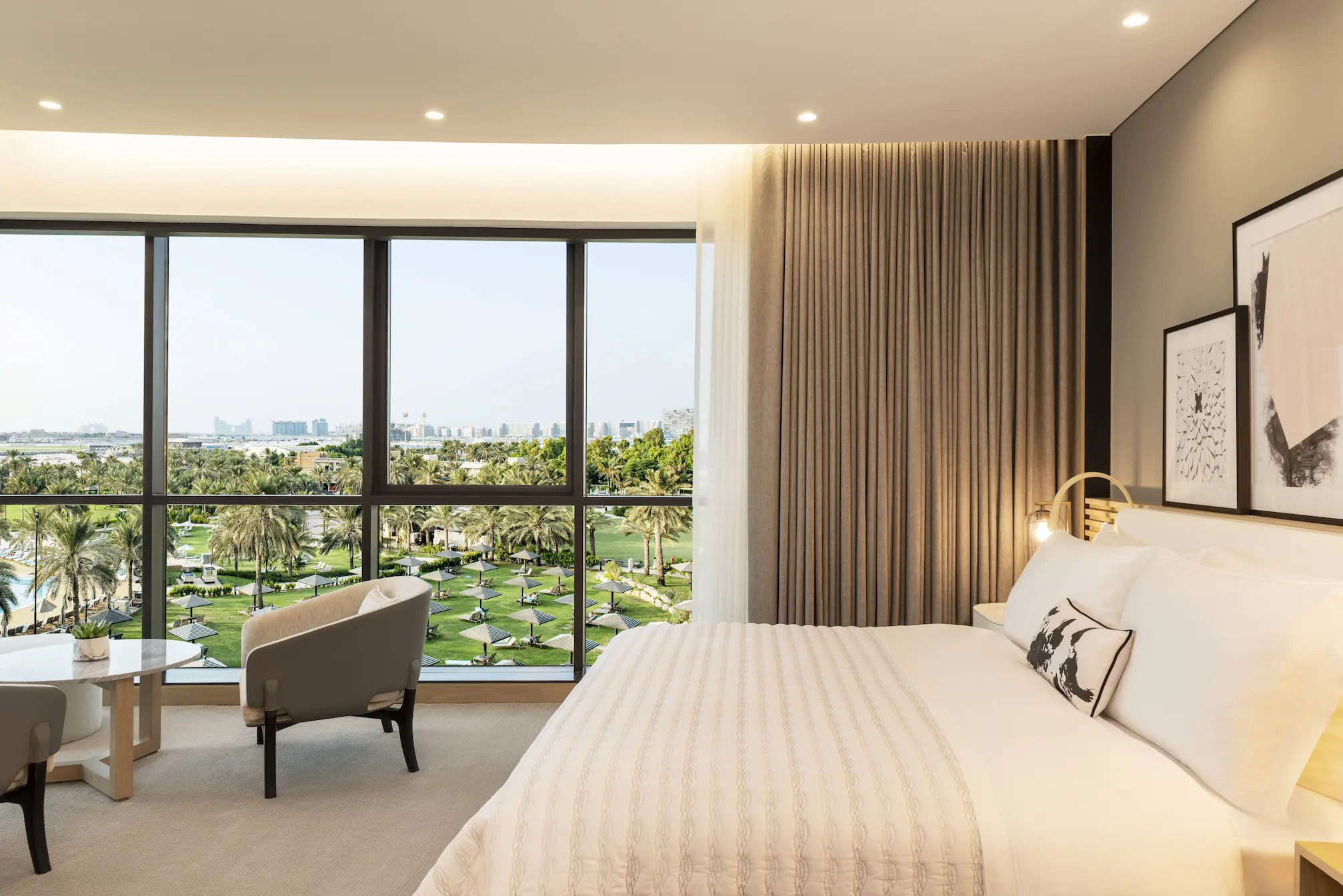 club suite master bedroom at le royal meridien beach resort and spa dubai featuring plush king-size bed, elegant modern furnishings and floor-to-ceiling windows with garden or sea views