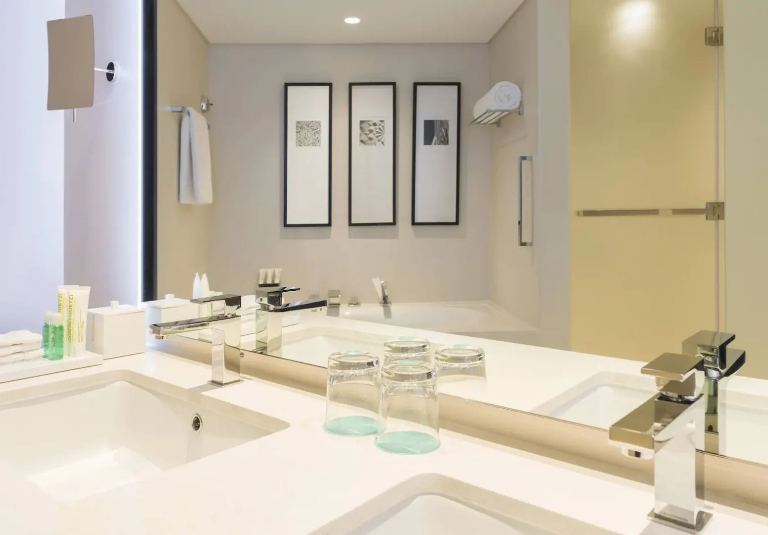 deluxe suite bathroom at le royal meridien beach resort and spa dubai featuring marble finishes, walk-in shower, bathtub and modern fixtures