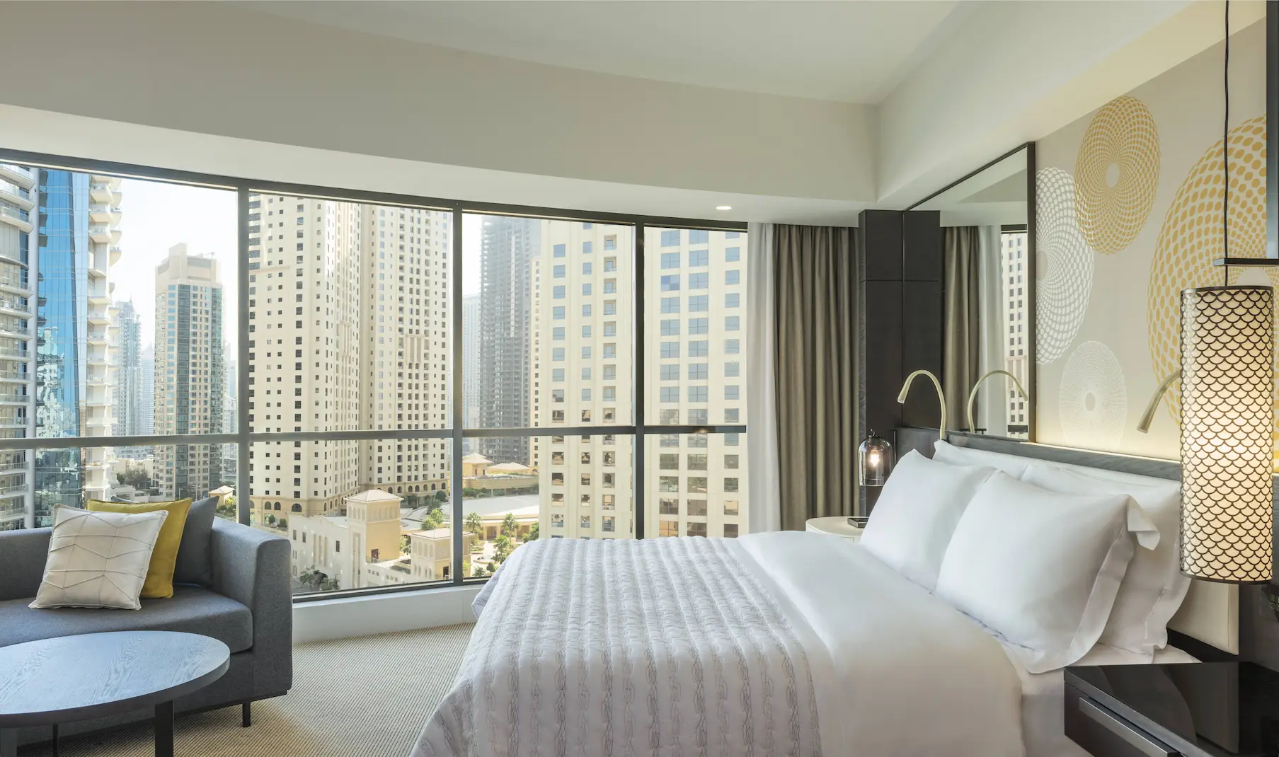 deluxe suite city view at le royal meridien beach resort and spa dubai featuring panoramic views of the dubai skyline from floor-to-ceiling windows