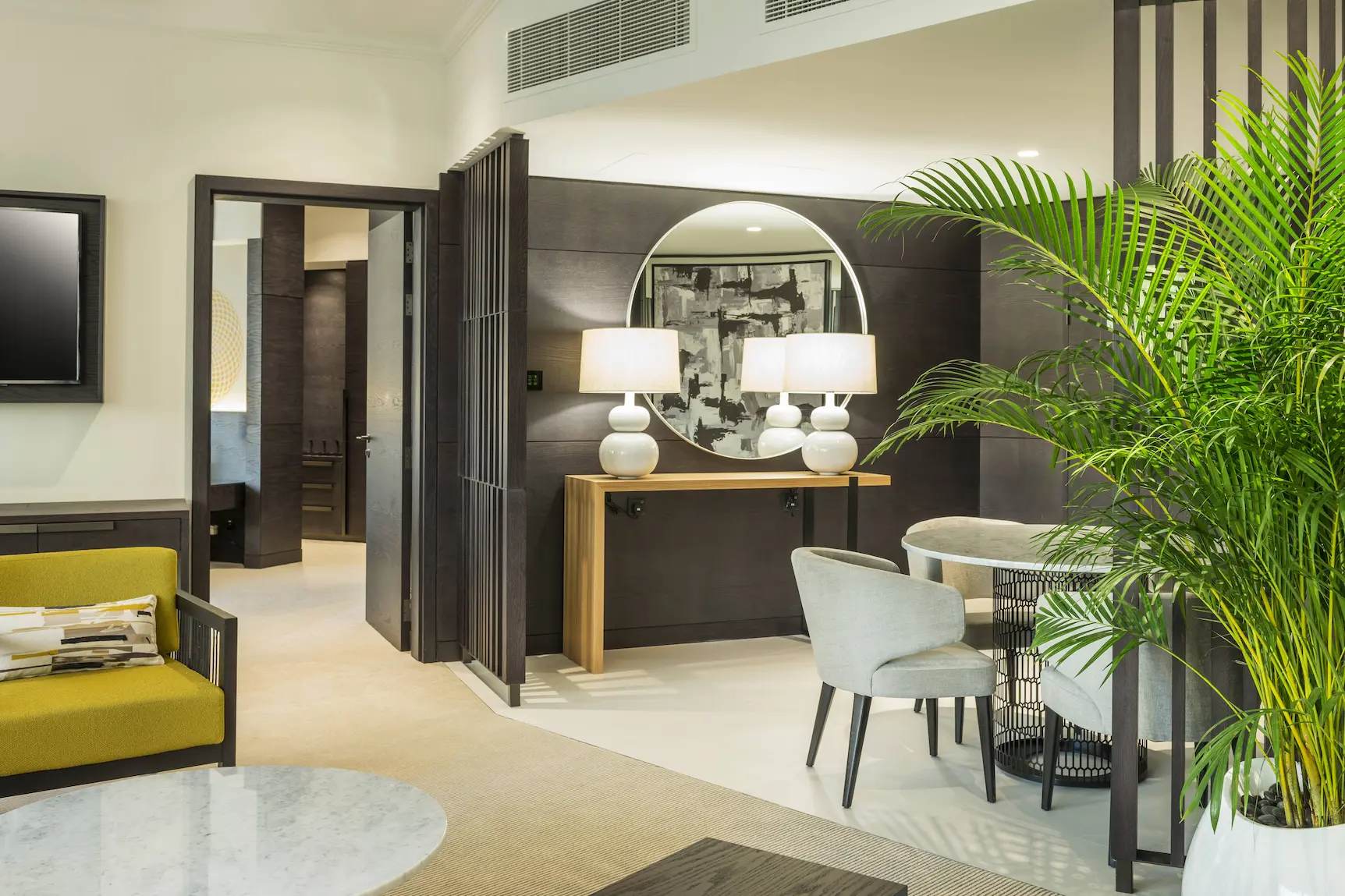 deluxe suite living area at le royal meridien beach resort and spa dubai featuring spacious seating, contemporary décor, coffee table and large windows with views of the arabian gulf or resort gardens