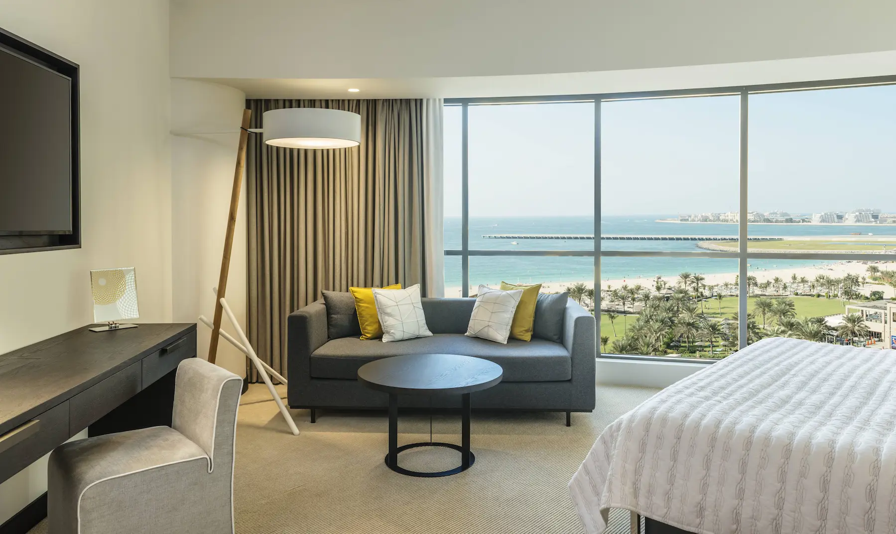 deluxe suite sofa area at le royal meridien beach resort and spa dubai featuring comfortable seating, modern décor and a relaxing space with views of the arabian gulf or resort gardens