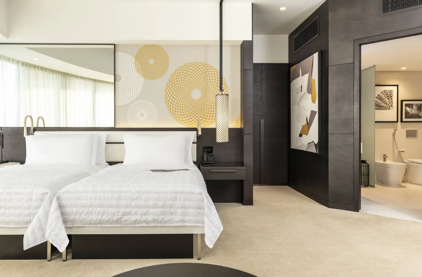 deluxe suite twin bedroom at le royal meridien beach resort and spa dubai featuring two twin beds, modern elegant décor, spacious living area and large windows with views of the arabian gulf or resort gardens