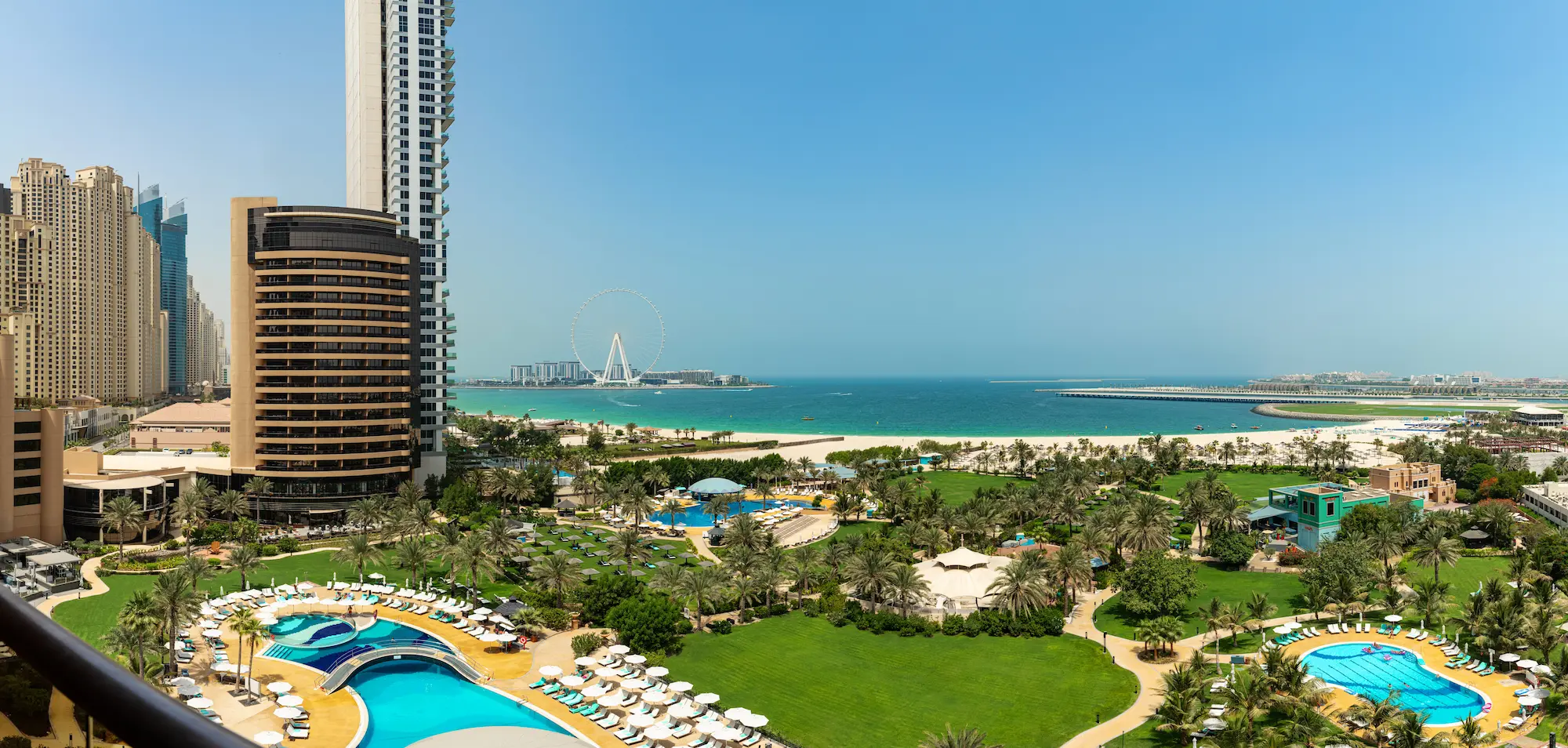 exterior view of le royal meridien beach resort and spa dubai featuring landscaped gardens, resort entrance and arabian gulf in the background