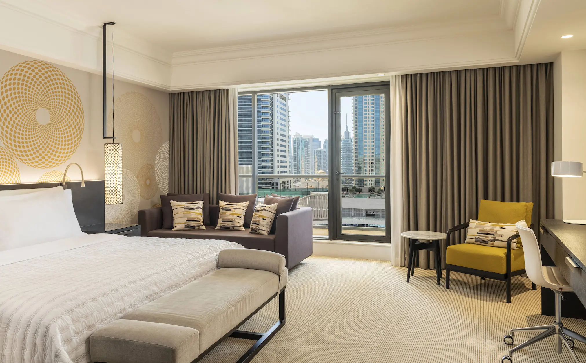 main deluxe king city view bedroom at le royal meridien beach resort and spa dubai featuring king-size bed, contemporary furnishings and large windows overlooking the dubai skyline