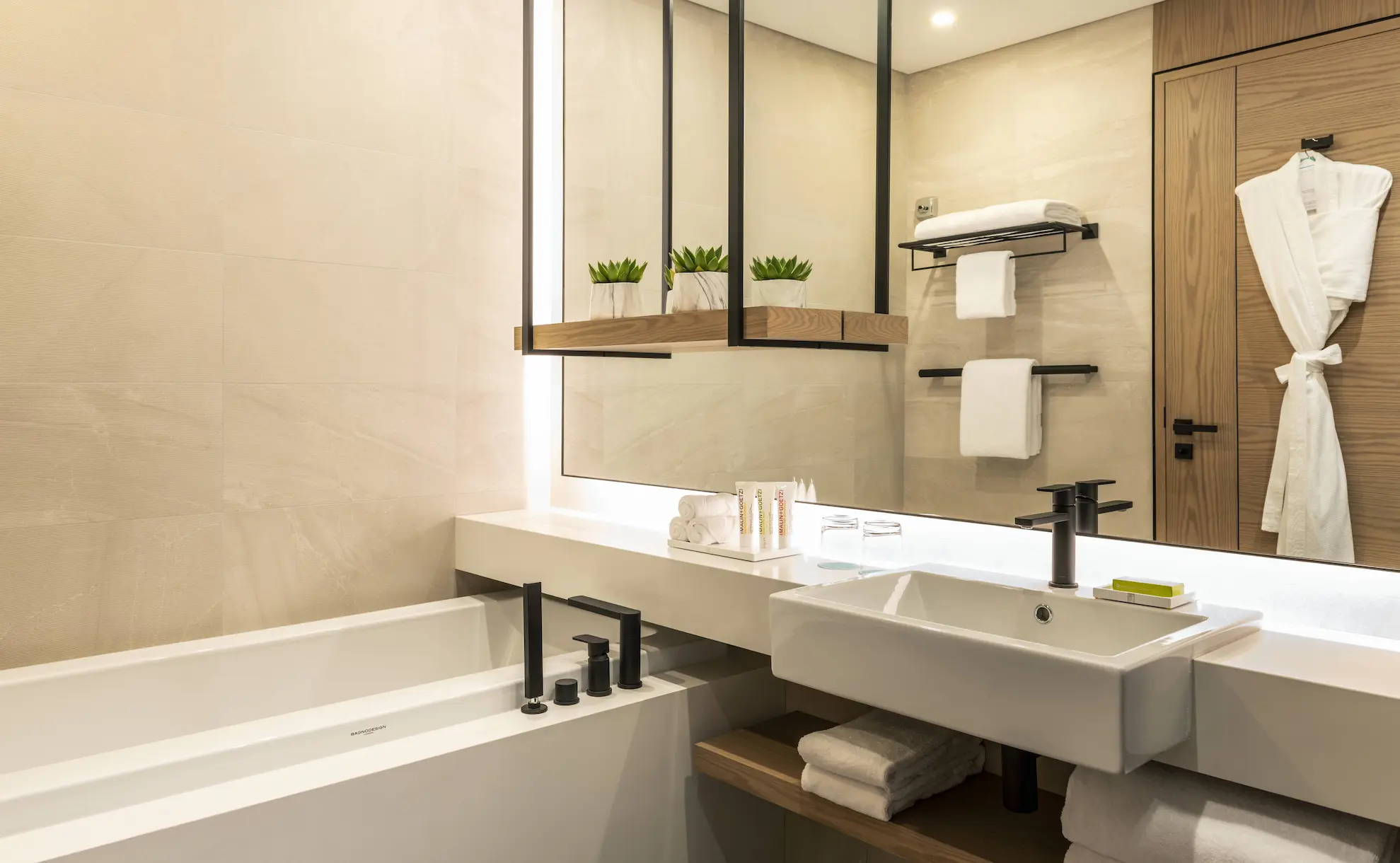 royal club bathroom at le royal meridien beach resort and spa dubai featuring marble finishes, walk-in shower, bathtub and contemporary fixtures