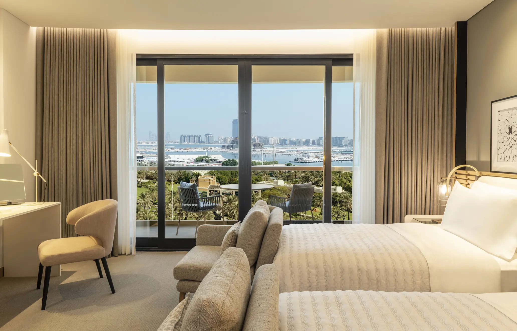 royal club tower twin bedroom at le royal meridien beach resort and spa dubai featuring two twin beds, contemporary décor and large windows with views of the arabian gulf or resort gardens