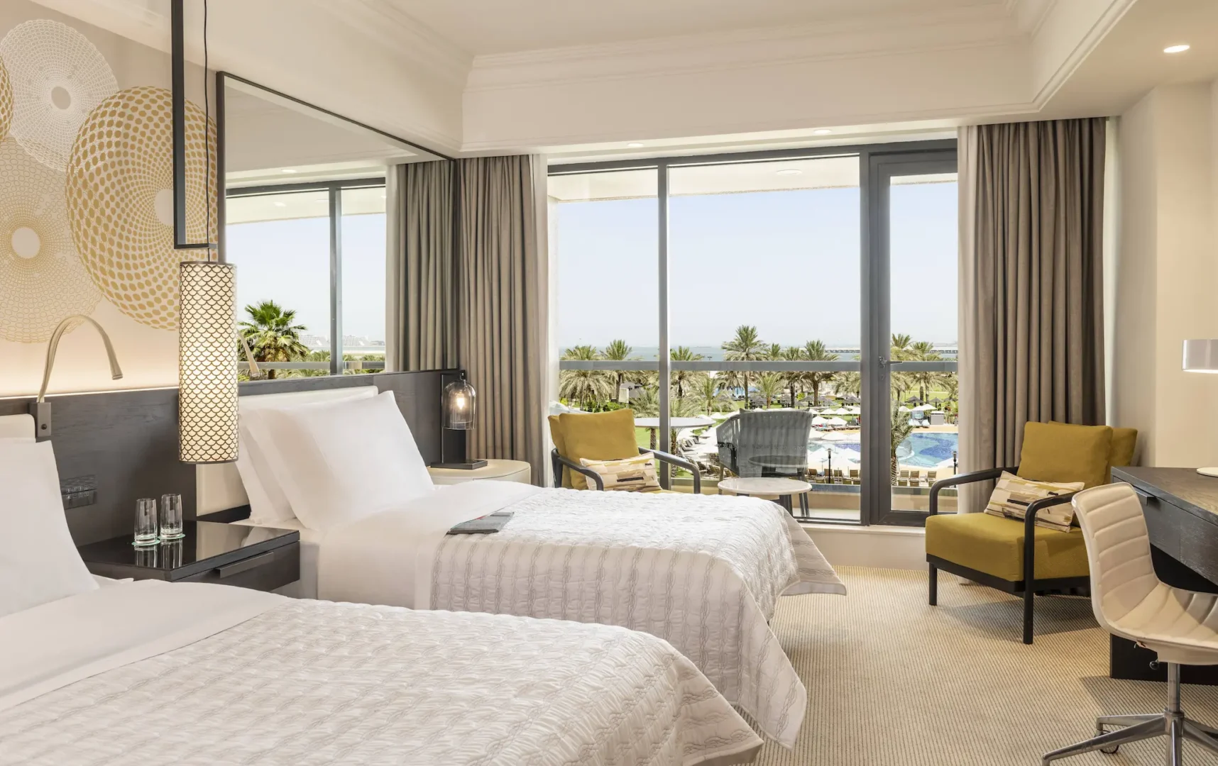 superior deluxe sea view twin bedroom at le royal meridien beach resort and spa dubai featuring two twin beds, contemporary décor and private balcony overlooking the arabian gulf
