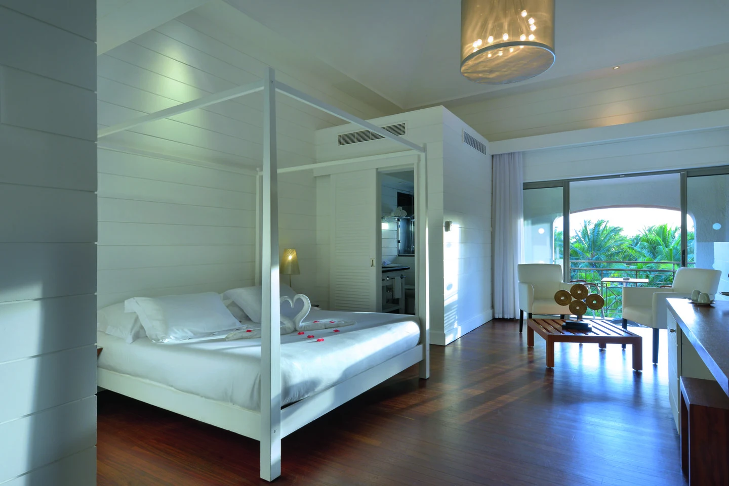 mauricia loft bedroom with king size bed, seating area, and tropical garden views