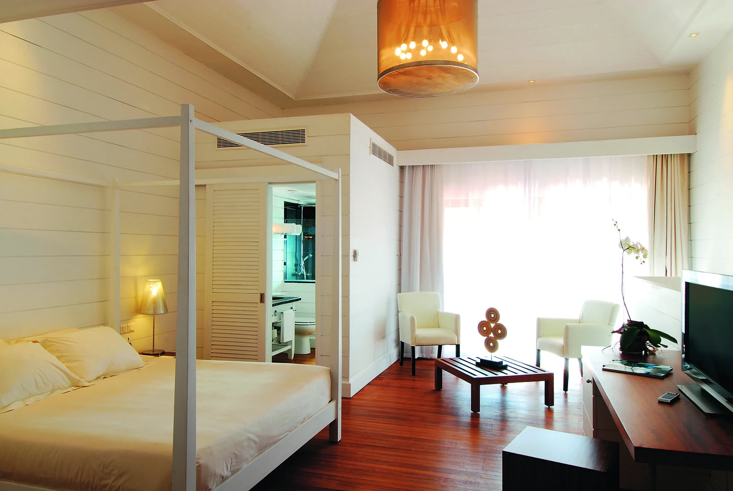 mauricia loft room with open living space, bedroom area, and balcony overlooking tropical gardens