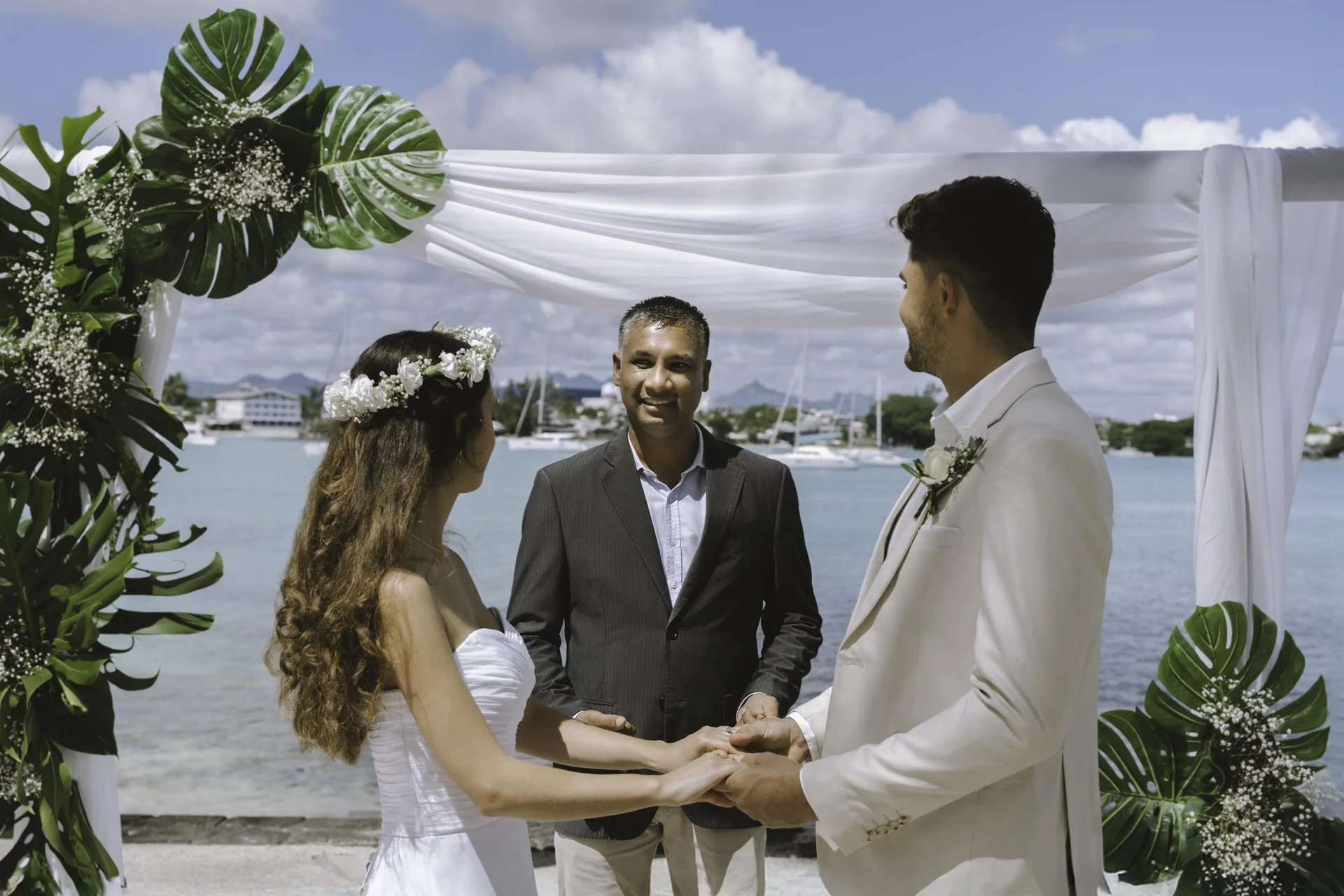 mauricia mauritius wedding altar on beachfront with floral arch and ocean backdrop