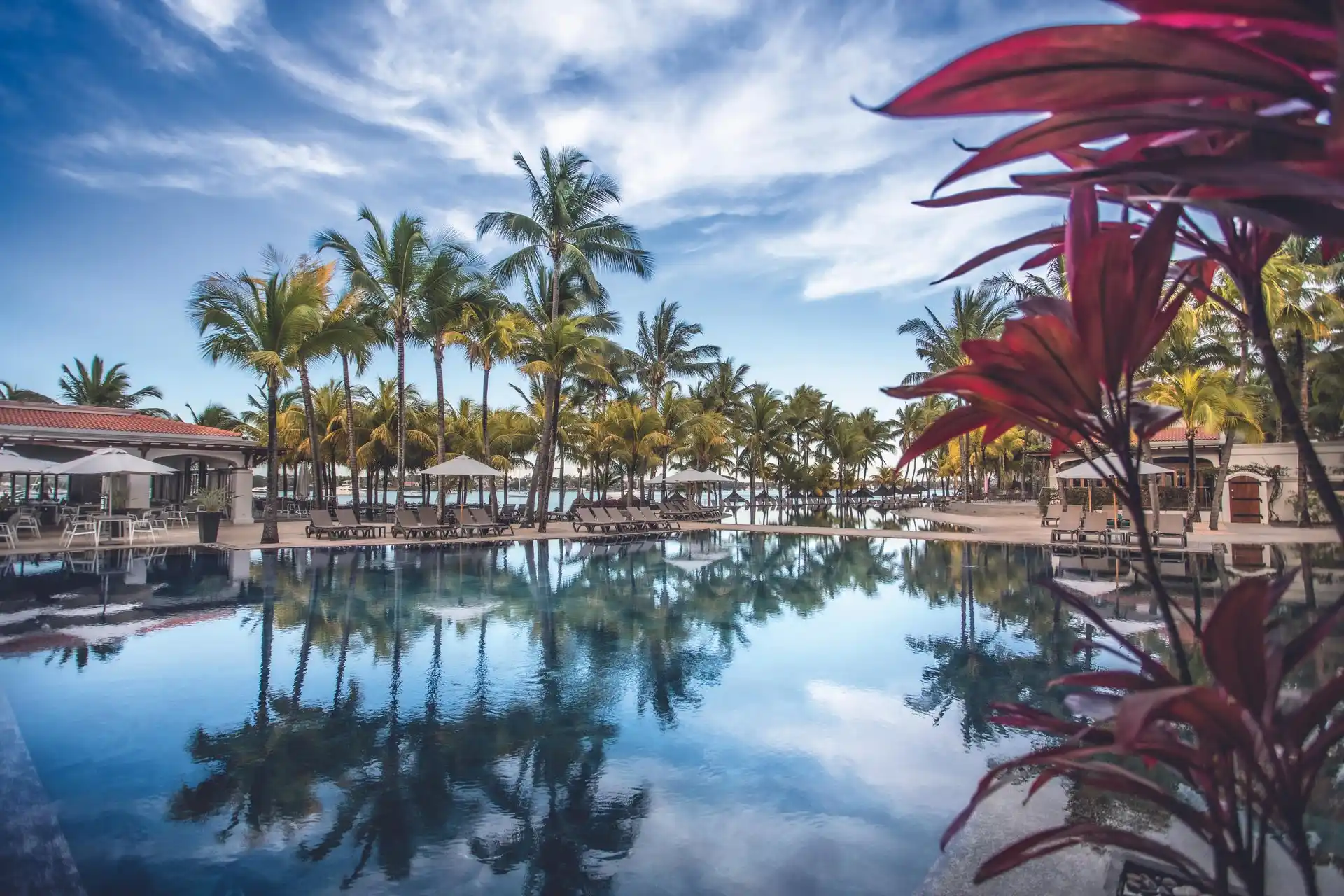 mauricia mauritius swimming pool with sun loungers and views of the turquoise lagoon
