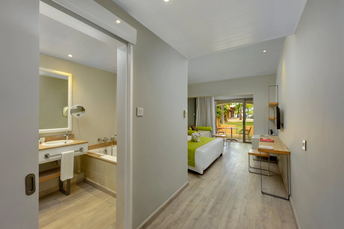 mauricia superior room ensuite bathroom with modern shower, bathtub, and tropical decor