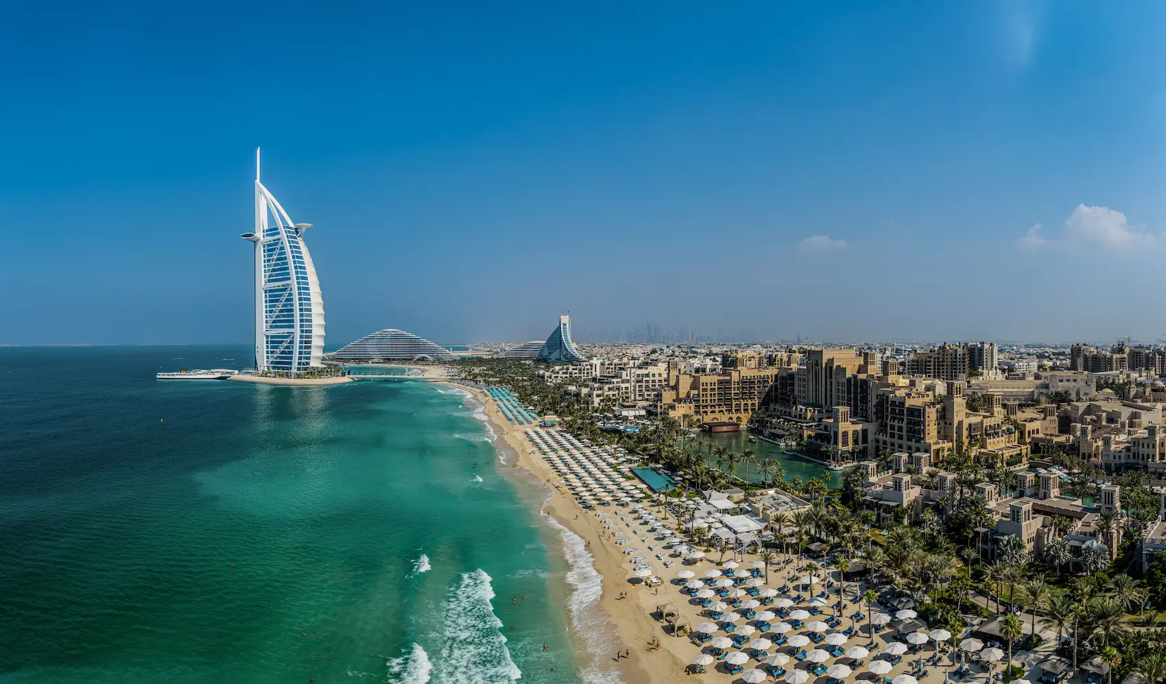aerial drone view of jumeirah beach hotel and surrounding coastline showcasing the resort layout and beachfront setting