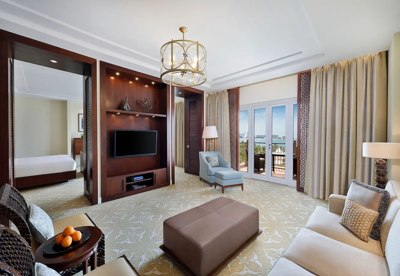 living room in one bedroom gulf club suite at the ritz-carlton dubai jbr luxury beachfront hotel featuring elegant seating area, modern interiors, and private balcony with arabian gulf views