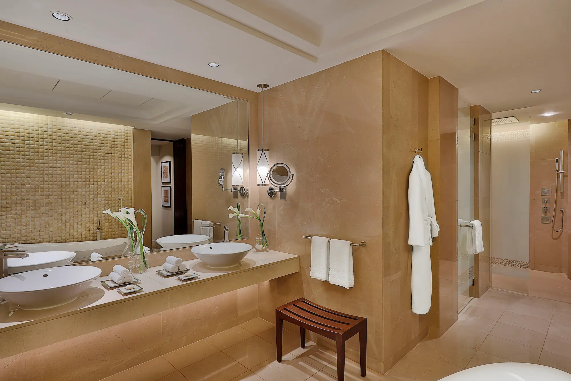 bathroom in one bedroom gulf suite at the ritz-carlton dubai jbr featuring marble finishes, deep soaking bathtub, walk-in shower, and luxury amenities with arabian gulf views