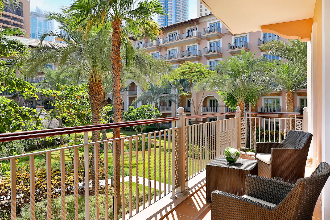 one bedroom gulf suite with garden view at the ritz-carlton dubai jbr luxury beachfront hotel featuring spacious living area, elegant interiors, and private balcony overlooking landscaped gardens