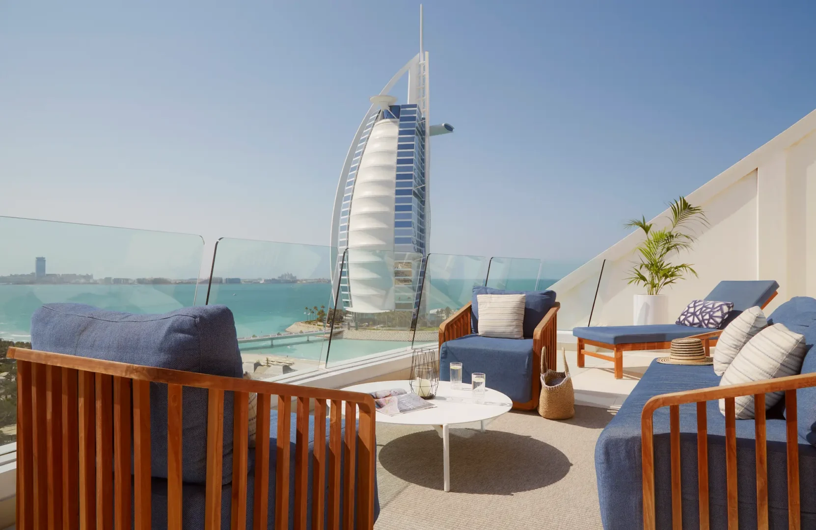 landscaped terrace of one bedroom ocean suite at Jumeirah Beach Hotel with outdoor seating and views across the resort gardens and arabian gulf