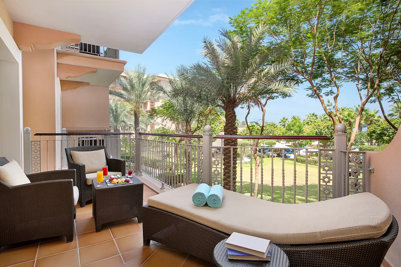 one bedroom suite with garden view at the ritz-carlton dubai jbr luxury beachfront hotel featuring spacious interiors, elegant living area, and private balcony overlooking landscaped gardens