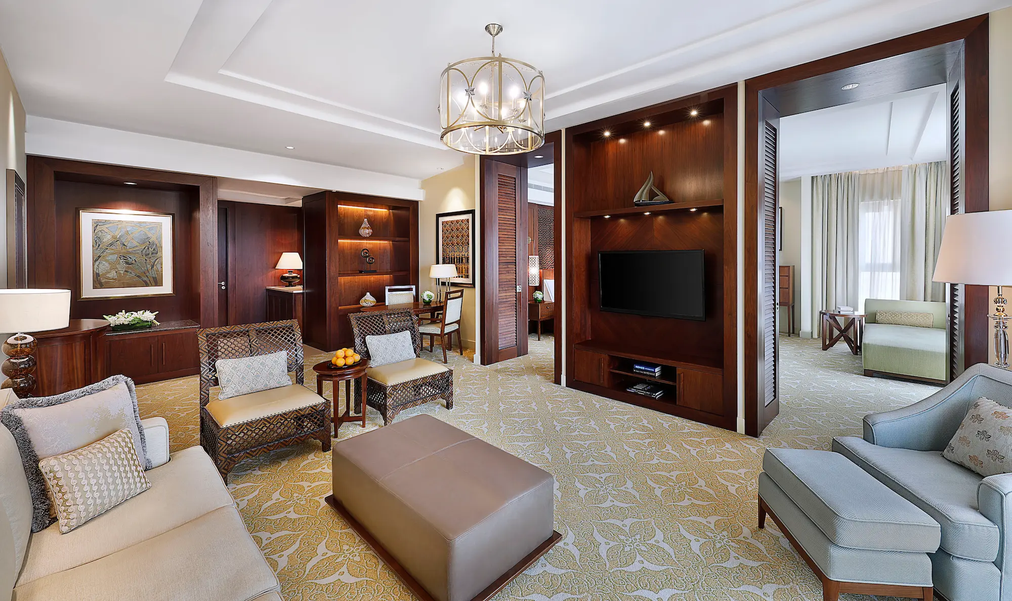living room in one bedroom suite with garden view at the ritz-carlton dubai jbr luxury beachfront hotel featuring elegant seating area, modern interiors, and private balcony overlooking landscaped gardens