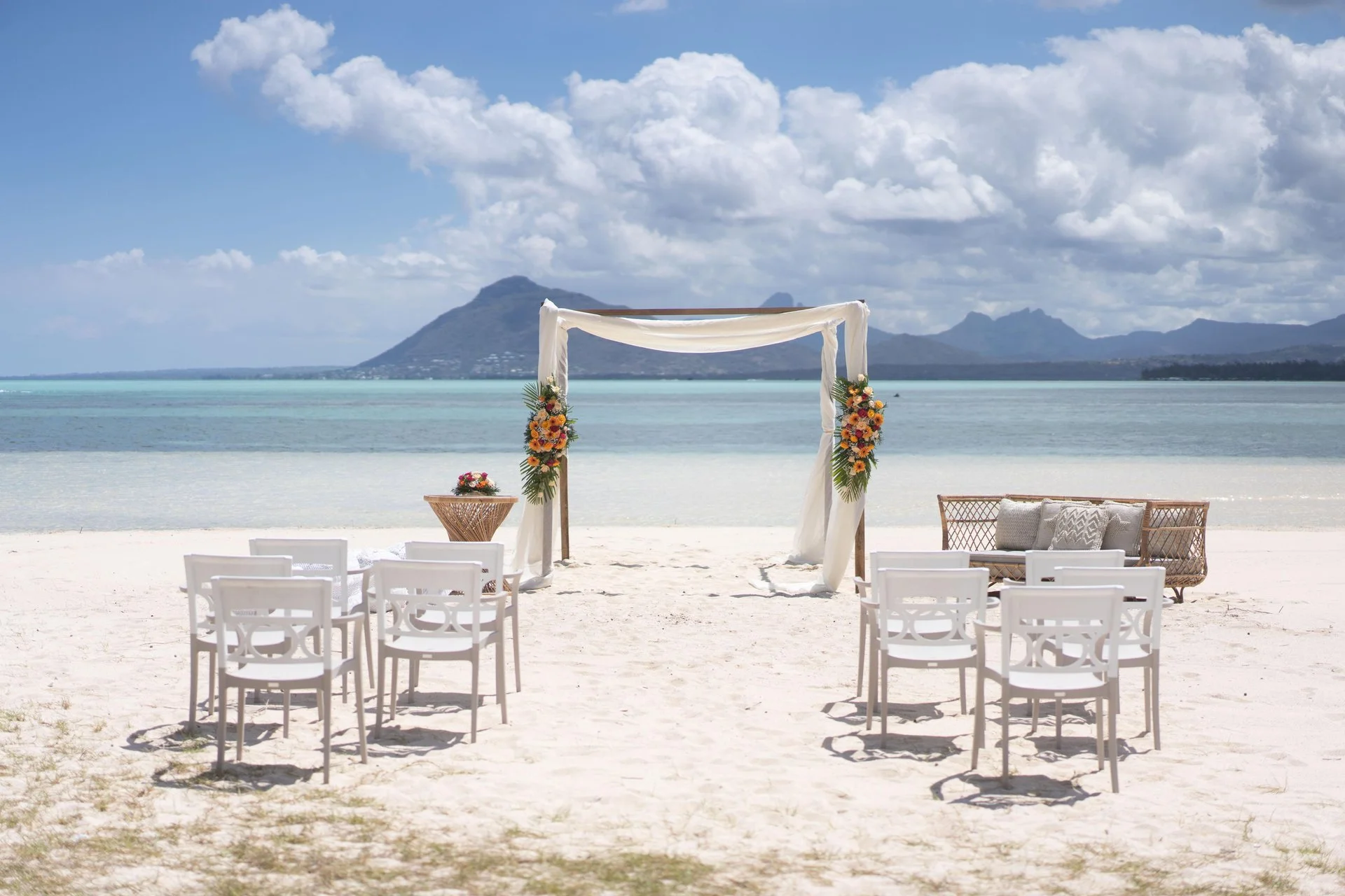 paradis mauritius wedding set up on beachfront with elegant floral arch and ocean view