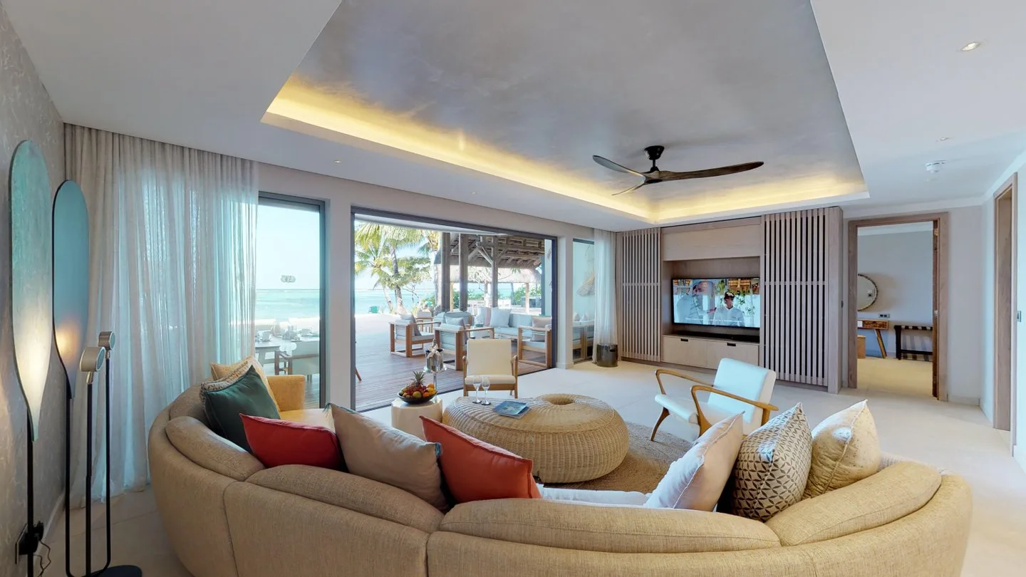paradis presidential villa bedroom with lounge area and tv