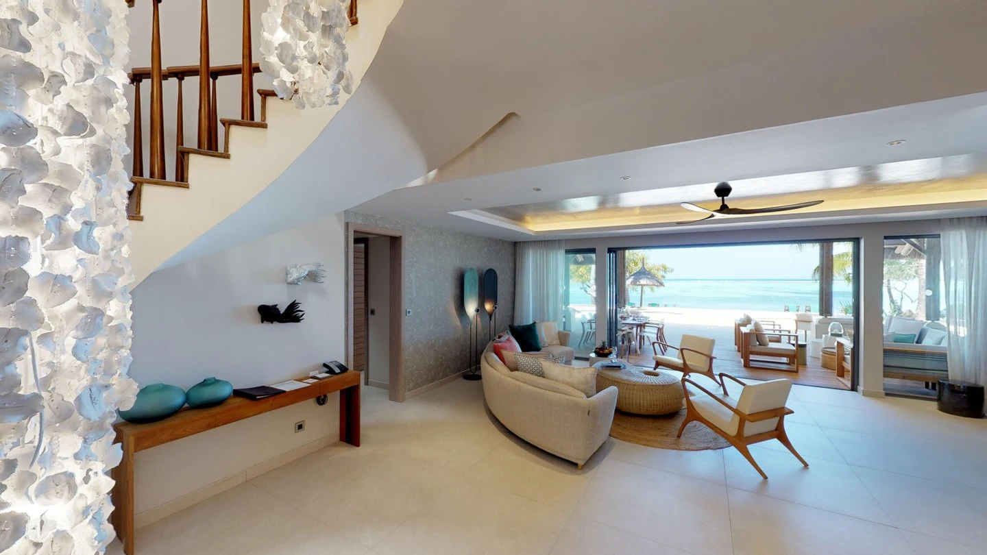 paradis presidential villa bedroom with lounge area and beachfront view