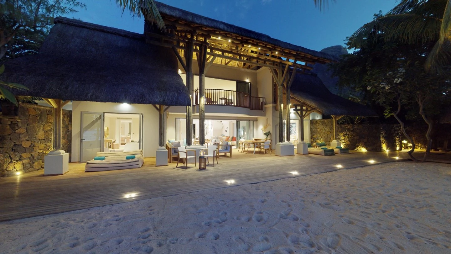 paradis presidential villa bedroom at night with beachfront view