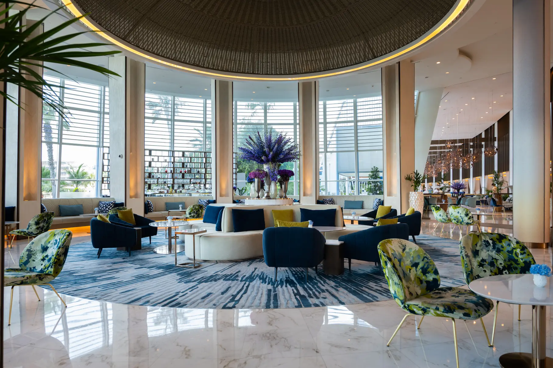 wide shot of pearl lounge at Jumeirah Beach Hotel showing elegant seating, soft lighting and refined contemporary lounge atmosphere
