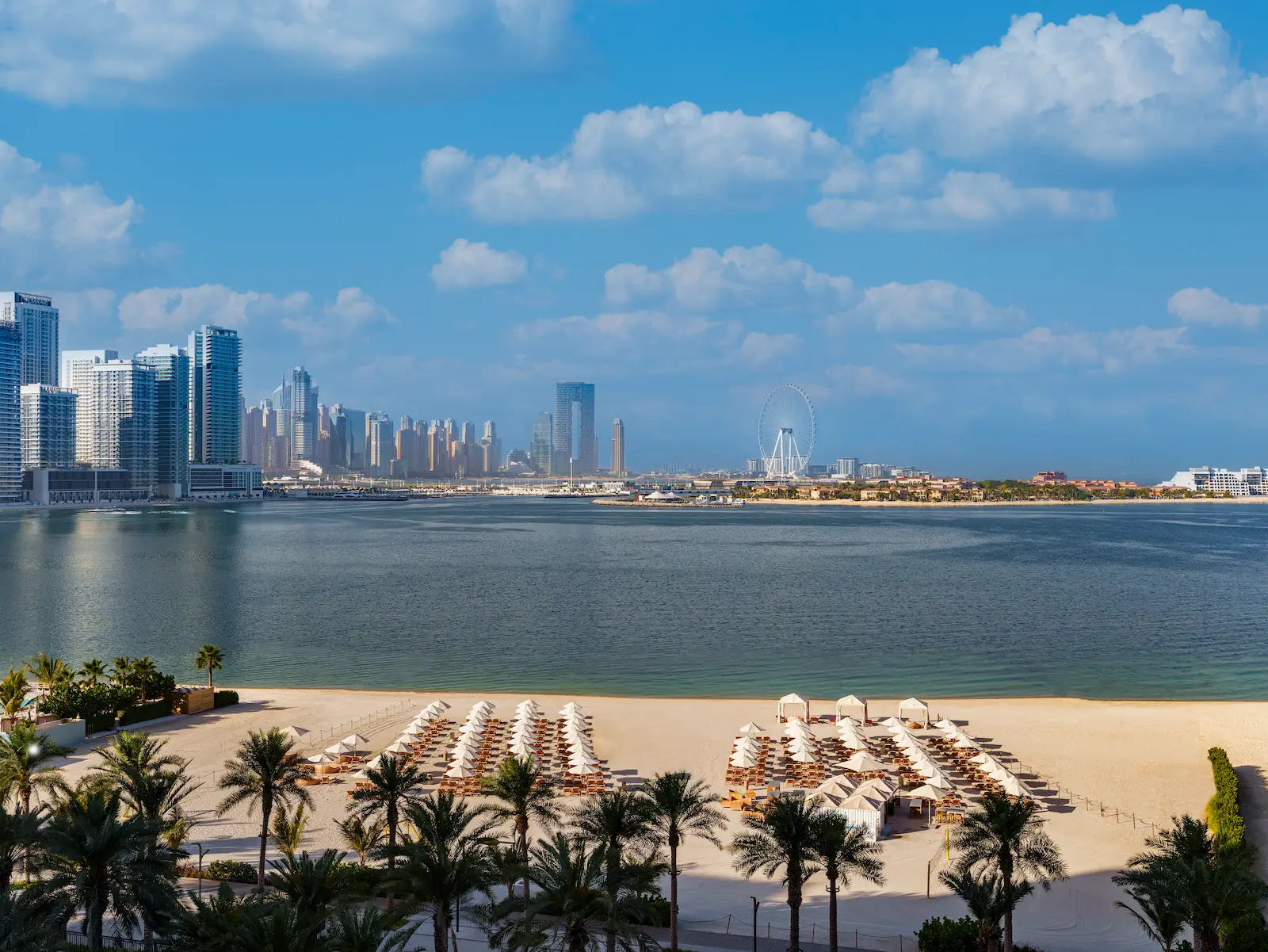 white-sand private beach at fairmont the palm dubai resort with sun loungers and calm waters