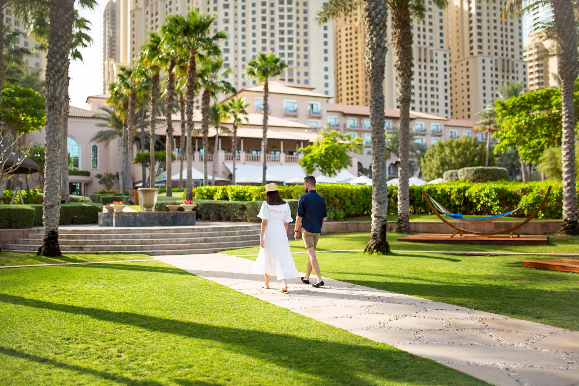 resort garden at the ritz-carlton dubai jbr featuring landscaped lawns, palm trees, and tranquil luxury beachfront surroundings in dubai marina