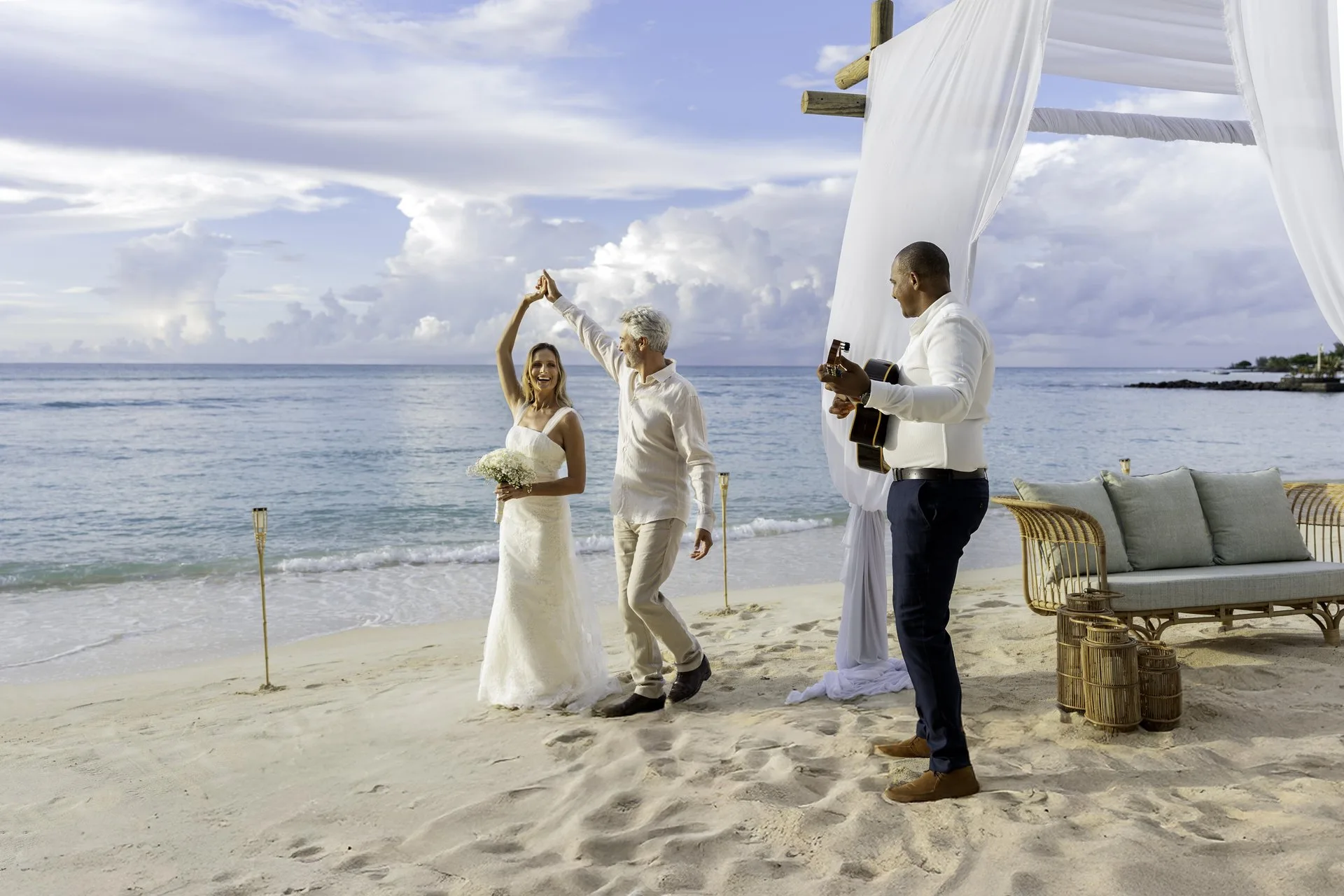 royal palm mauritius wedding dancing with bride and groom celebrating under evening lights on beachfront