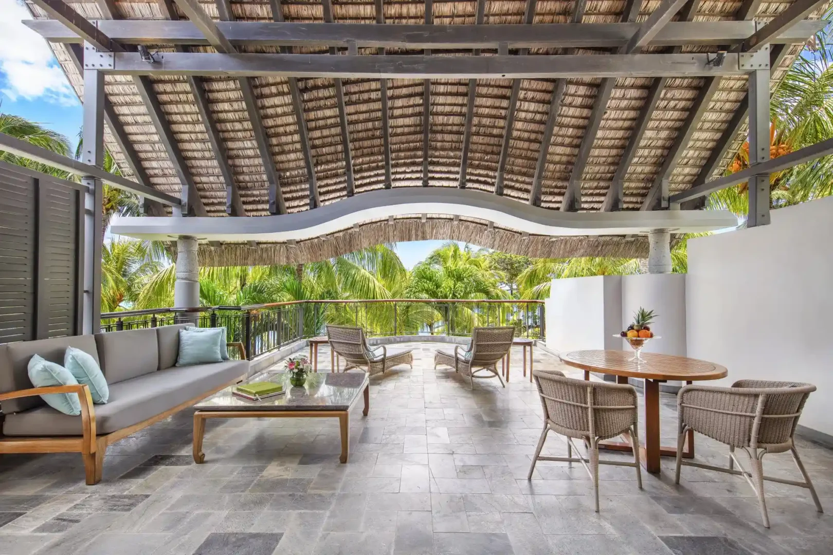 Here’s a lowercase alt text for that image: Alt text: "royal palm penthouse suite balcony with seating area and view of the surroundings