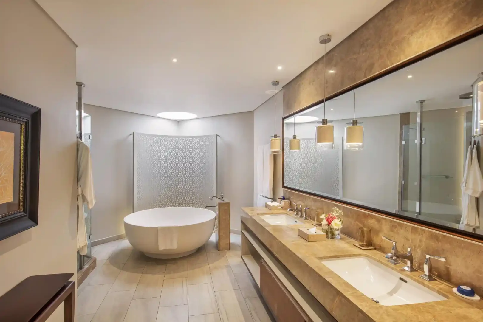 royal palm penthouse suite bath with bathtub, shower, and elegant vanity area