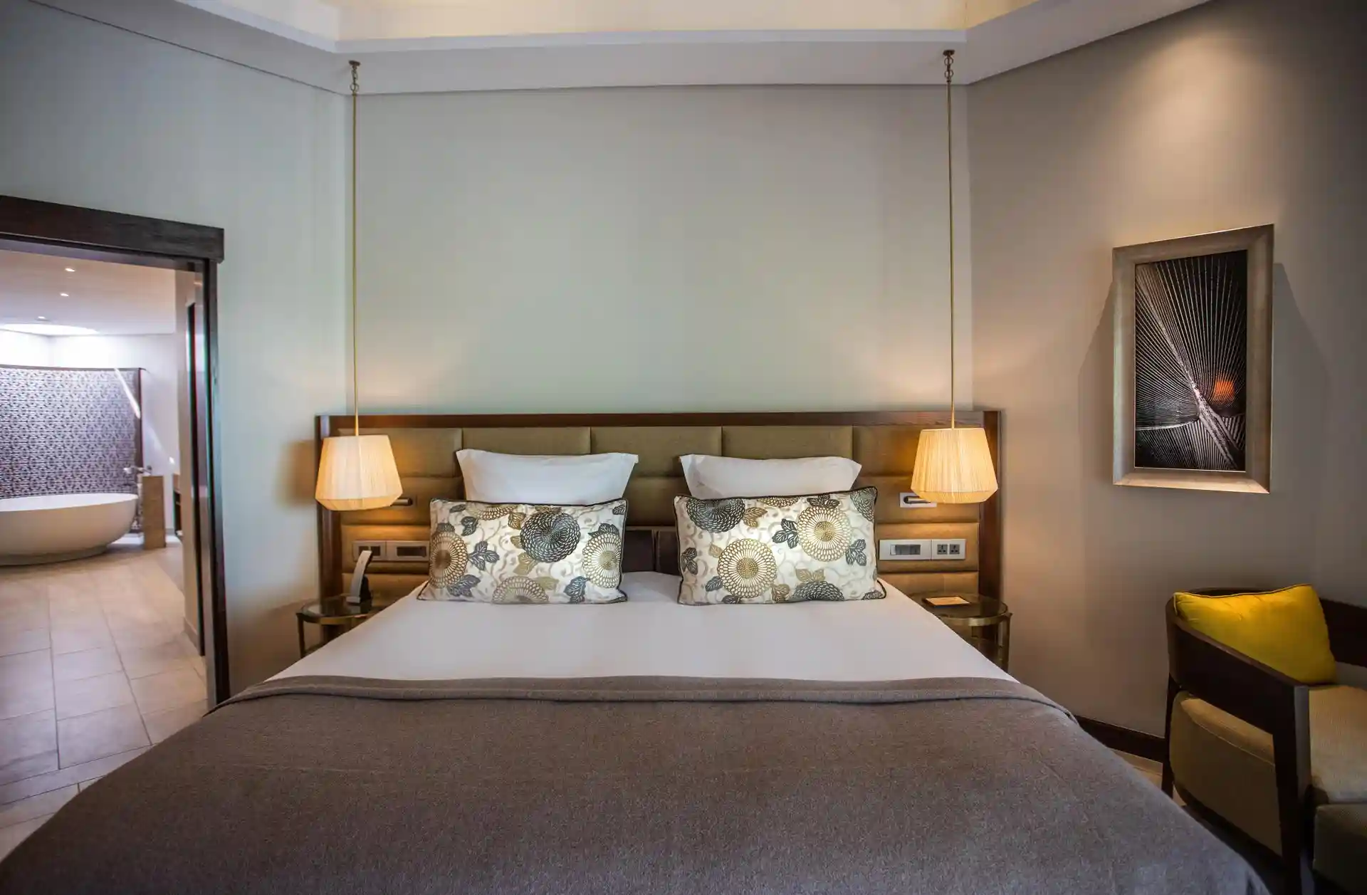 royal palm penthouse suite bedroom with attached bathroom, including shower, bathtub, and vanity area