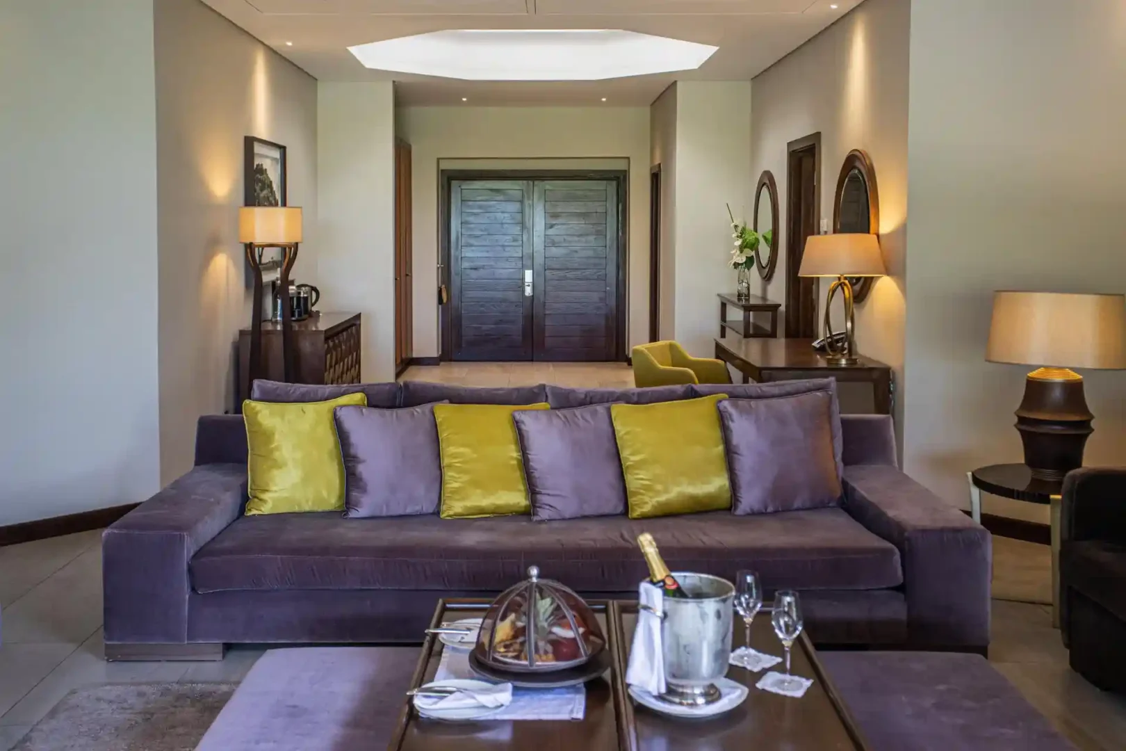 royal palm penthouse suite lounge with seating area, sofa, chairs, coffee table, and large windows