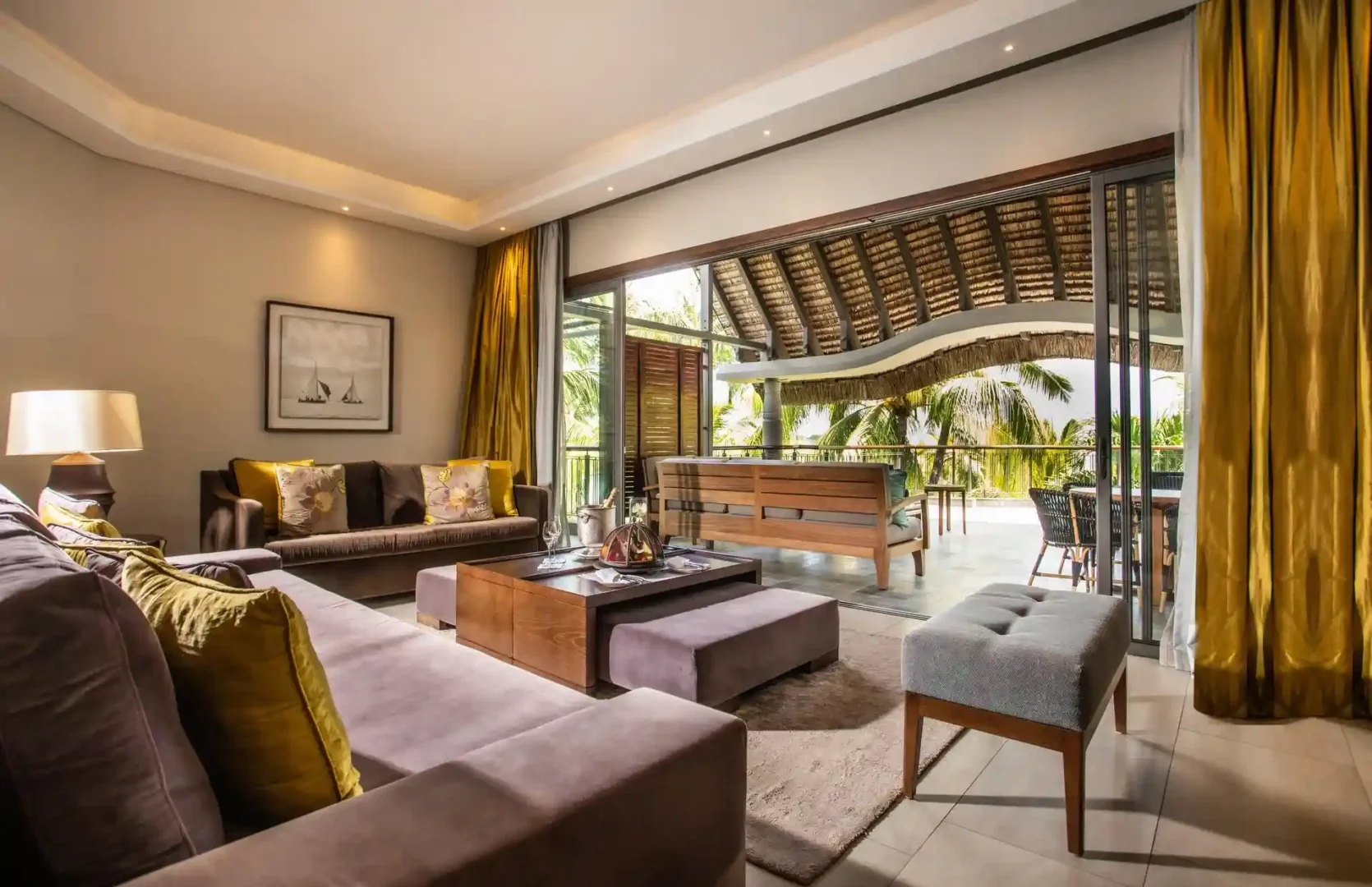 royal palm penthouse suite outdoor lounge with seating area, chairs, tables, and view of the surroundings
