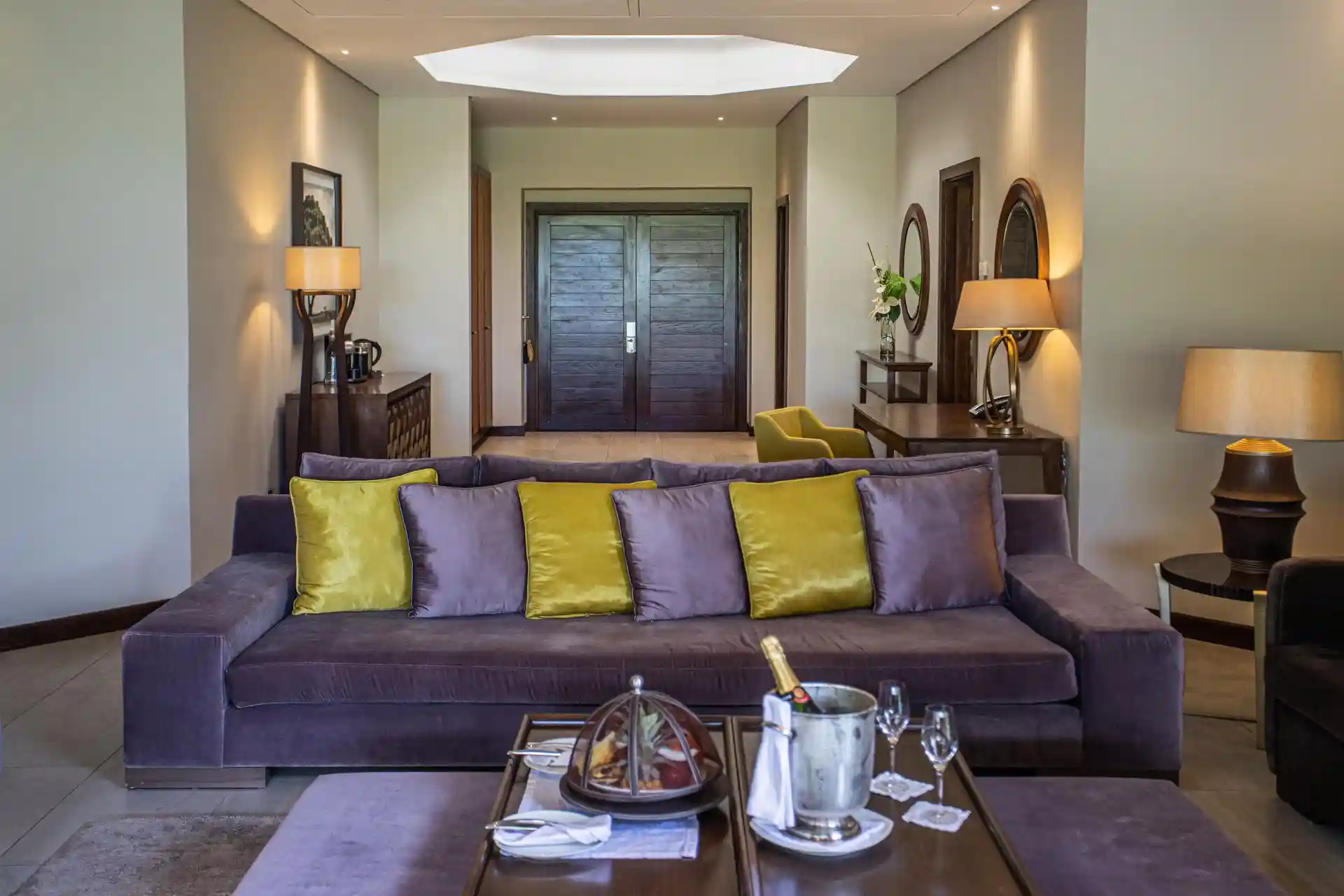 royal palm penthouse suite lounge with seating area, sofa, chairs, coffee table, and large windows