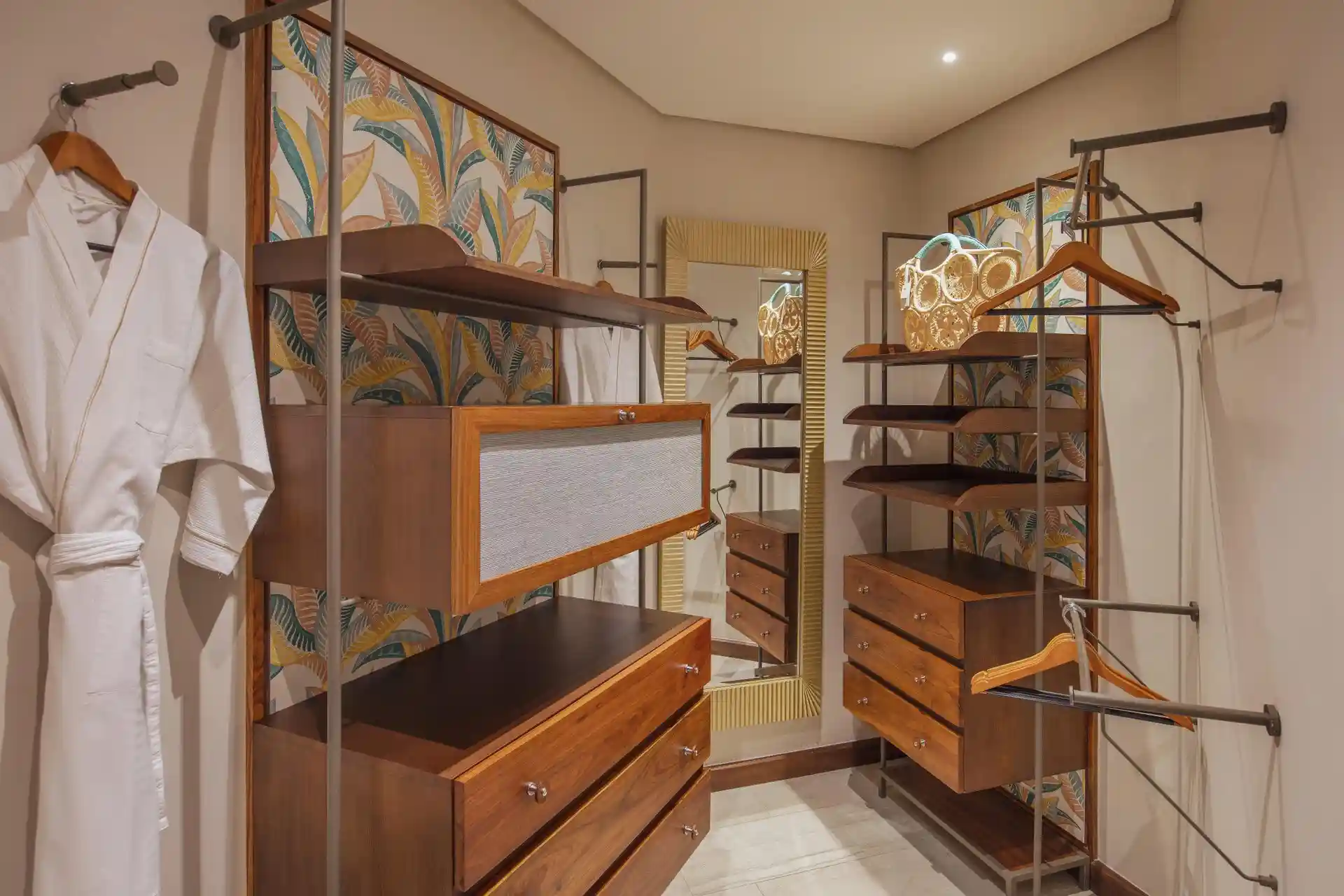 royal palm penthouse suite wardrobe with built-in shelves, hanging space, and drawers