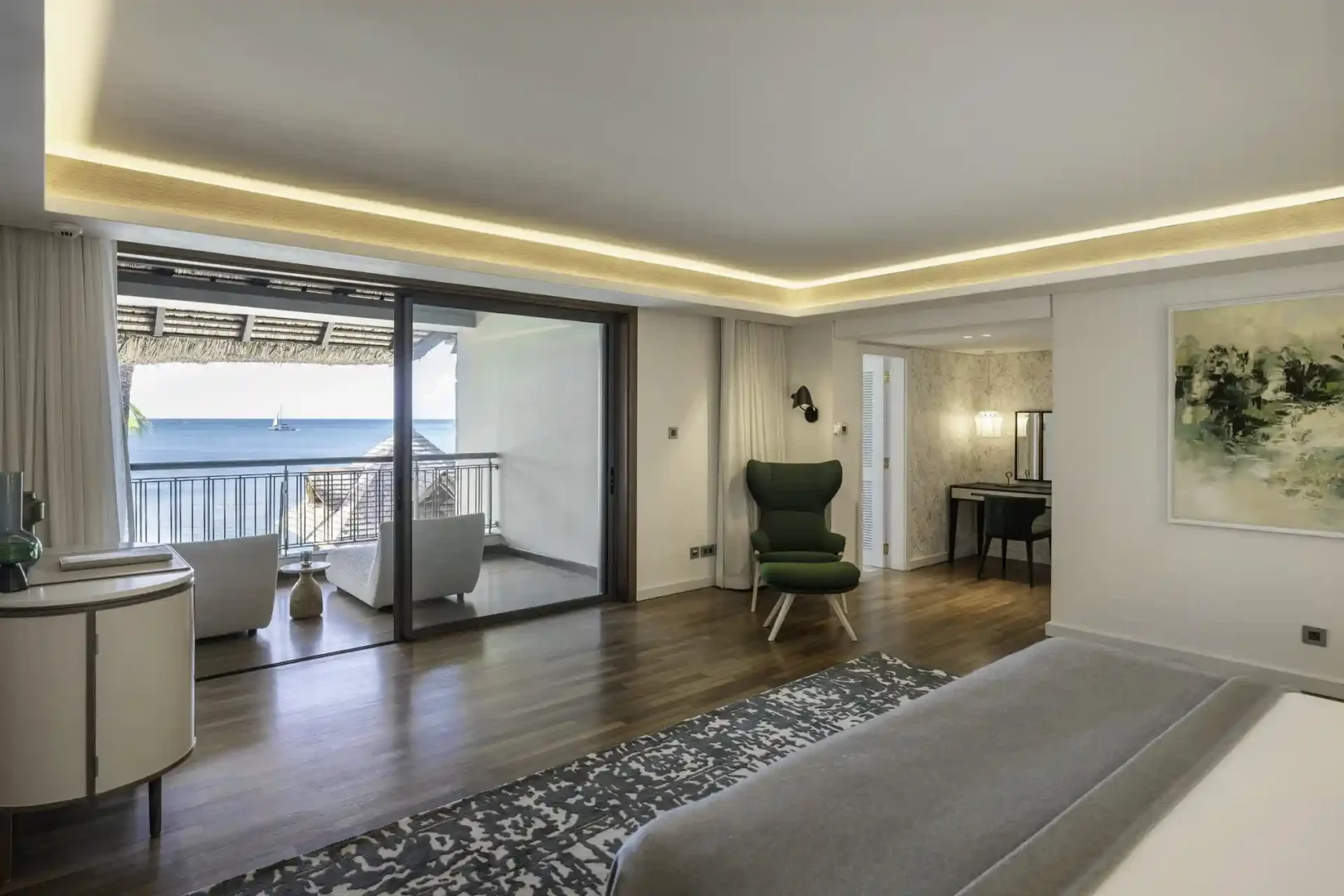 royal palm royal villa bedroom with balcony, seating area, and view of the surroundings