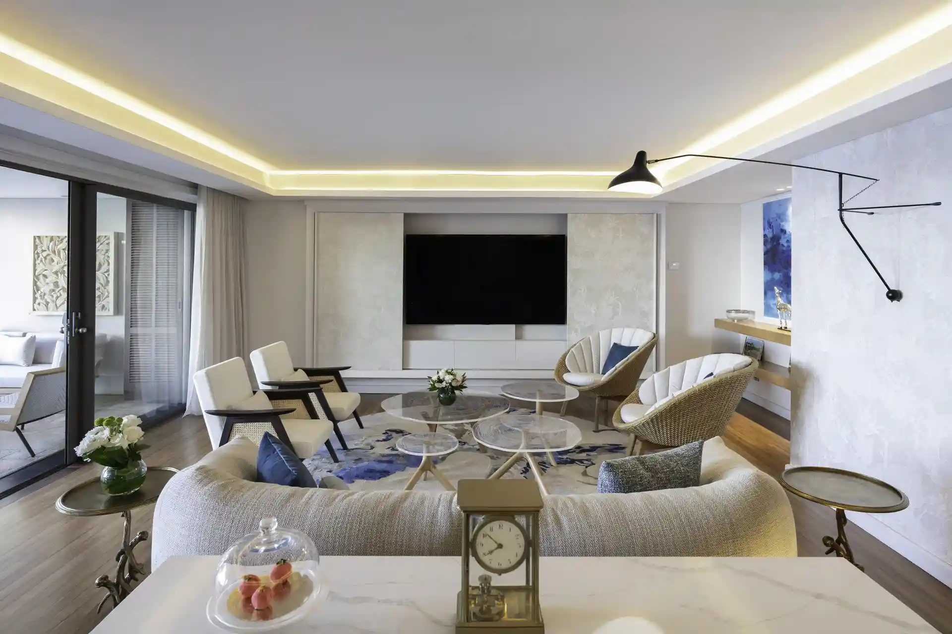 royal palm royal villa lounge with sofa, chairs, coffee table, and large windows