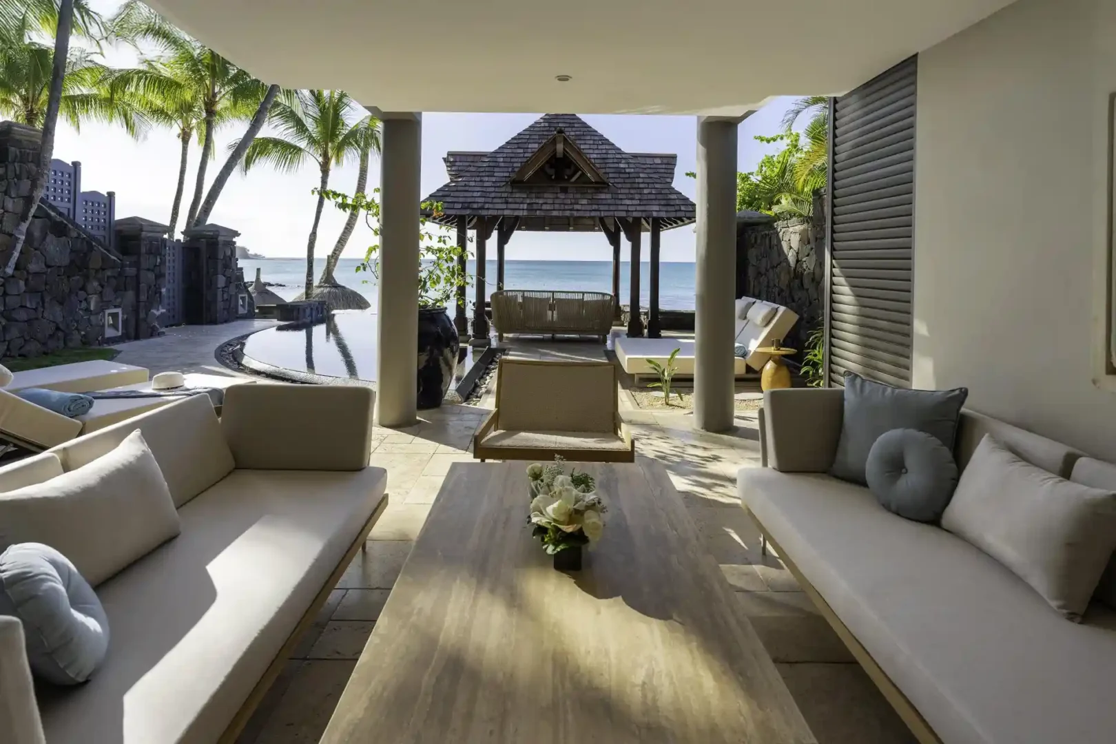 Here’s a lowercase alt text for that image: Alt text: "royal palm royal villa outdoor lounge with seating area, chairs, tables, and surrounding views