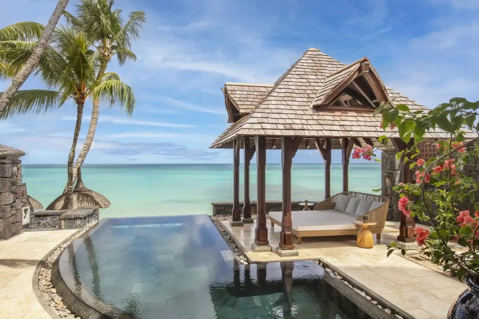 royal palm royal villa pool with surrounding lounge area, chairs, and landscaping