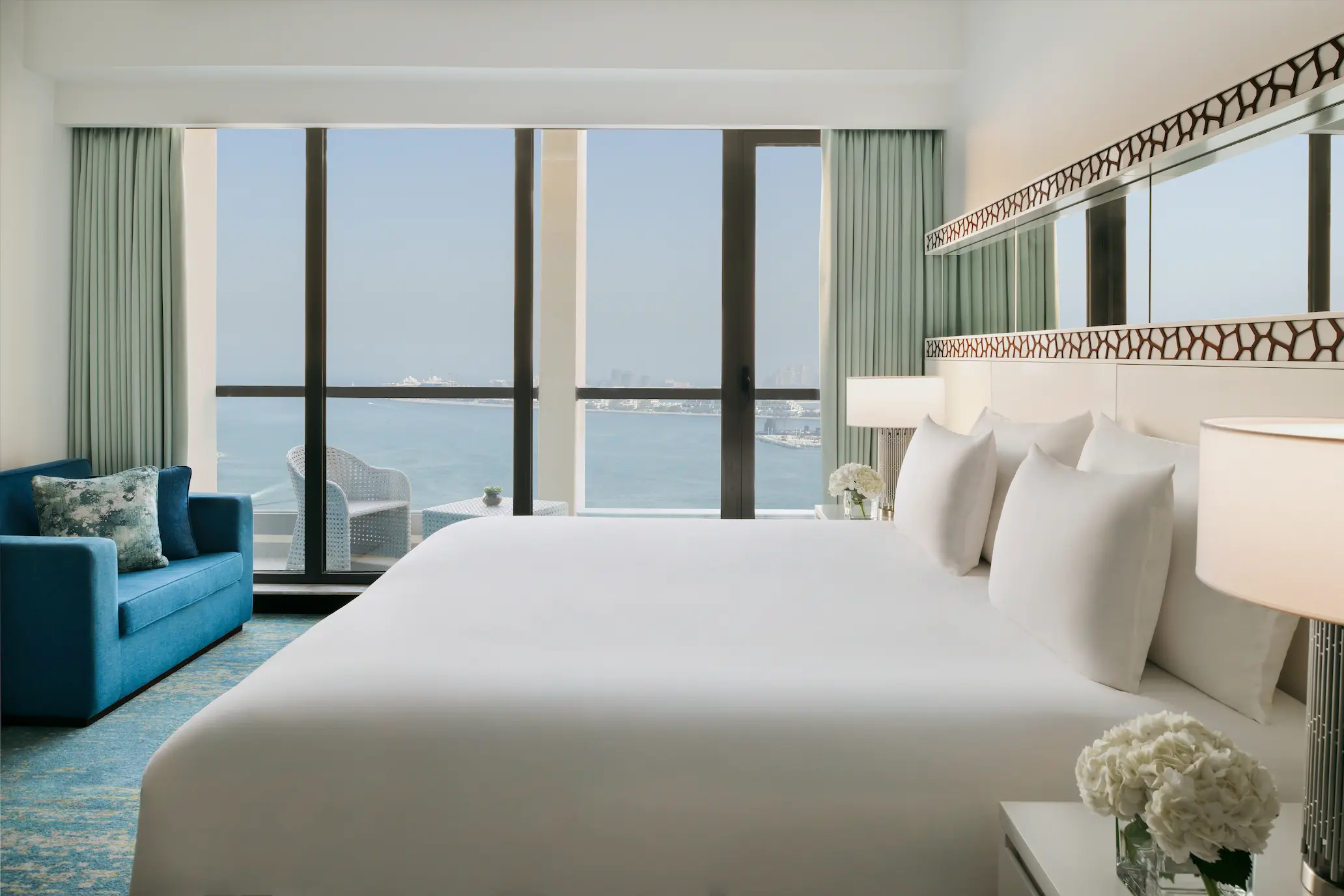 sea view club room at ja ocean view hotel with king bed and balcony overlooking the arabian gulf
